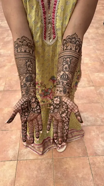 Full-arm bridal mehndi with elephants and temple domes