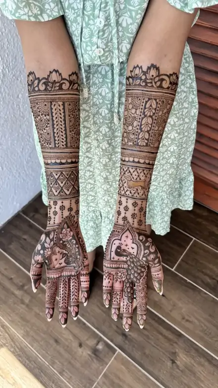 Mehndi on a bride's hands against a green outfit